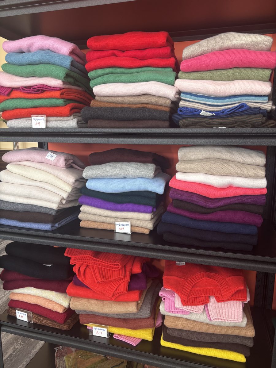 Folded cashmere sweaters in assorted colours on a shelf