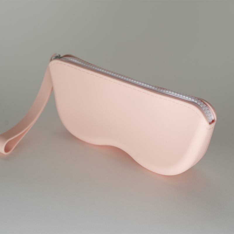 A soft pink silicone glasses case with a zip and a wrist strap